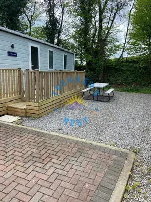 a backyard with a picnic table and a bench at Trekkers Rest, Brigham, Cockermouth, Cumbria in Cockermouth