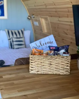 a basket of food is sitting on a table at Craigend Farm Holiday Pods - The Curly Coo in Dumfries