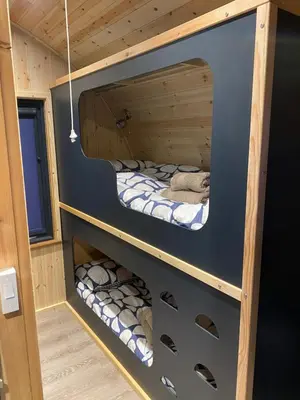 a bunk bed in a tiny house at Craigend Farm Holiday Pods - The Curly Coo in Dumfries