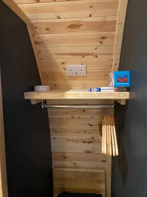 a wooden wall with a shelf and a lightswitch at Craigend Farm Holiday Pods - The Curly Coo in Dumfries