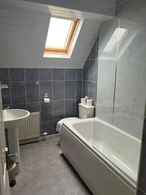 a bathroom with a bath tub and a sink at The Calder House Hotel in Seascale