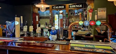 a bar in a pub with a counter top at The Calder House Hotel in Seascale