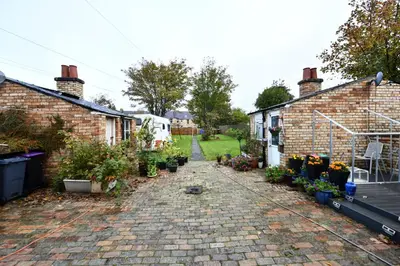 a garden with some plants and some buildings at The Wee Lion in Troon