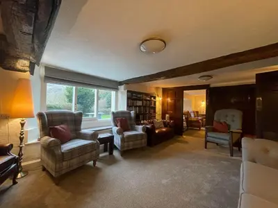 a living room with two chairs and a couch at Seatoller House in Borrowdale Valley