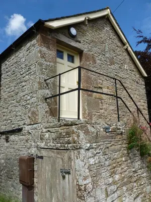 a stone house with a window and a door at The Old Map Shop in Wigton