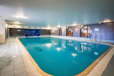 a large swimming pool in a hotel room at Bowscale Suite in Penruddock