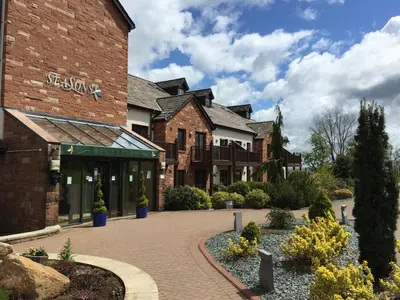 a brick building with a brick driveway in front at Bowscale Suite in Penruddock