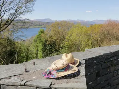 two hats sitting on top of a stone wall at Fellside View in Ambleside