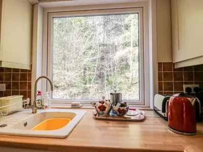 a kitchen counter with a sink and a window at Fellside View in Ambleside