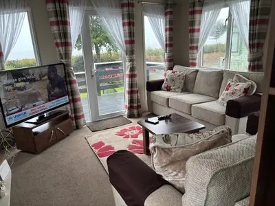 a living room with a couch and a tv at Coyles retreat in Stranraer