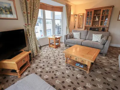 a living room with a couch and a tv at Peak View in Keswick