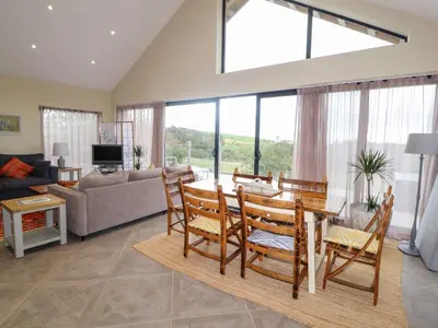 a living room with a table and a couch at The Lodge in Stranraer