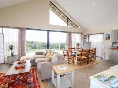 a living room with a couch and a table at The Lodge in Stranraer