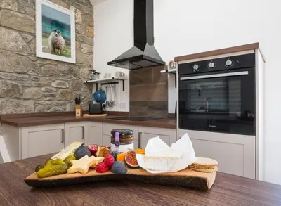 a tray of food on a table in a kitchen at Dairy Cottage in Gatehouse of Fleet