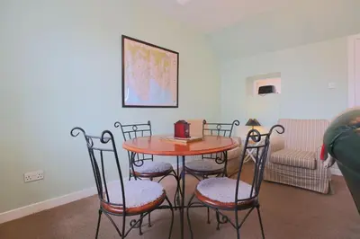 a table and chairs in a living room at Silver Lodge in Creetown