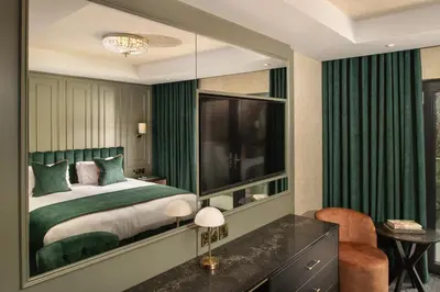 a bedroom with a bed and a large mirror at Brig o' Doon House Hotel in Ayr