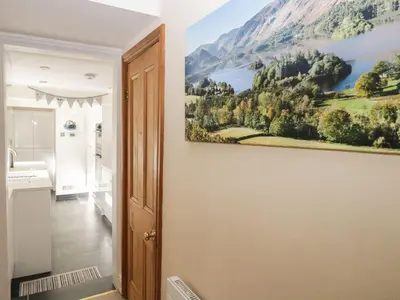a bathroom with a painting on the wall at Derwent Cottage in Keswick