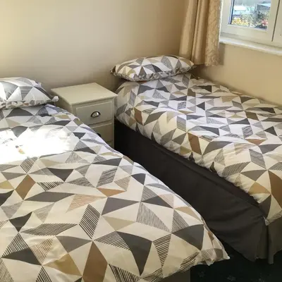 two beds sitting next to each other in a bedroom at Bobs plac in Whitehaven