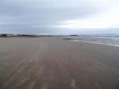 an empty beach with footprints in the sand at Links Quay 42 in Prestwick