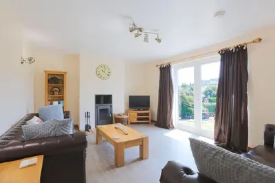 a living room with a couch and a table at Croftdean in East Barcloy