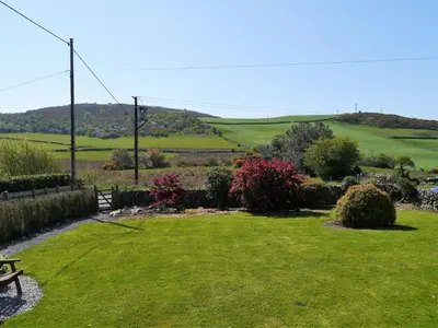 a park with a bench in the middle of a field at Croftdean in East Barcloy