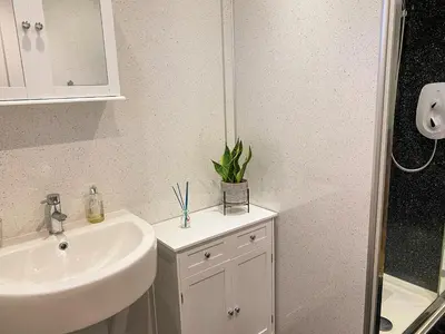 a bathroom with a sink and a mirror at Ardwell Park in Ardwell