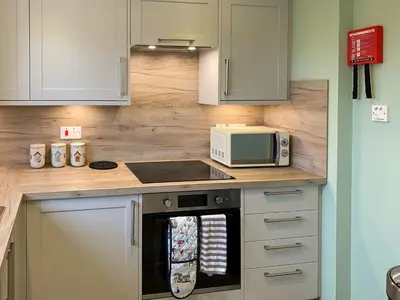a kitchen with a stove and a microwave at Ardwell Park in Ardwell