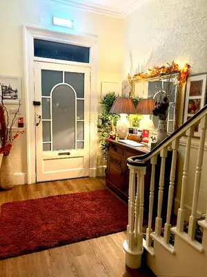 aoyer with a white door and a red rug at Ashleigh House in Carlisle
