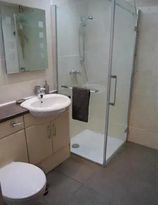 a bathroom with a shower and a sink and a toilet at Laurieknowe Coach House in Dumfries
