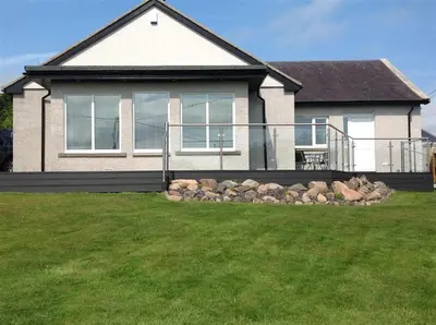a large house with a lawn in front of it at Firpoint in Rockcliffe