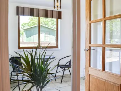 a dining room with a table and chairs and a window at The Byre - Camp Douglas - Cottage in Crossmichael