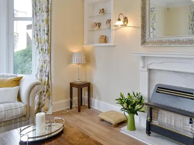 a living room with a couch and a fireplace at Cardoness Houses in Dumfries