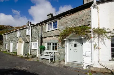 an old stone house with a white door at Bank View in Chapel Stile