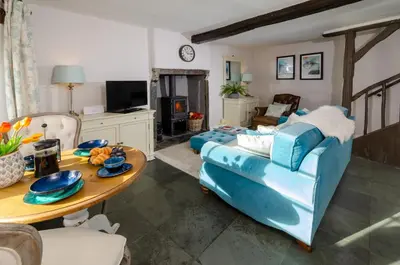 a living room with a blue couch and a table at Bank View in Chapel Stile