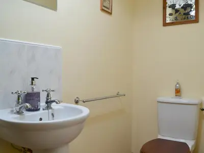 a bathroom with a white sink and a toilet at Middle Howe in Portinscale