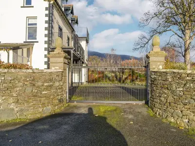 a gate to a house with a stone wall at Middle Howe in Portinscale