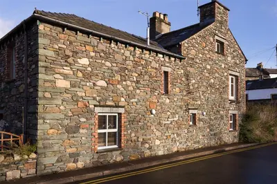 a stone building on the side of a street at Agathi in Keswick