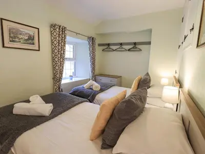a bedroom with two beds with their legs on the wall at Slaters Rest in Chapel Stile
