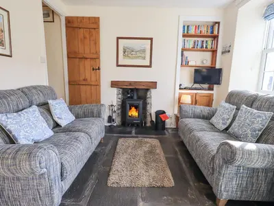 a living room with two couches and a fireplace at Slaters Rest in Chapel Stile