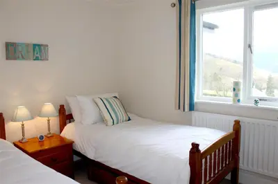 a bedroom with two twin beds and a window at Bandol in Braithwaite