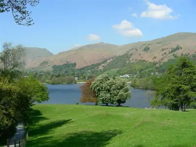 a view of a river with mountains in the background at Dovecot Cottage in Ambleside