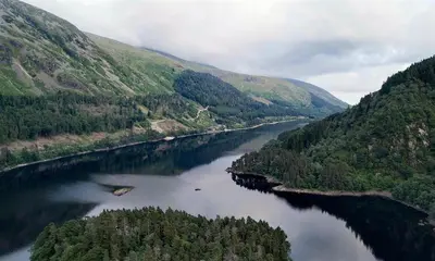 an aerial view of a river between two mountains at Thirlmere Cottage in Keswick