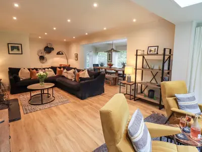 a living room with a couch and a table at Underheron in Grasmere