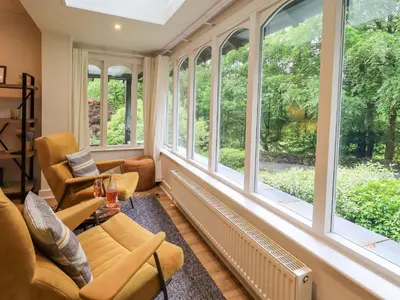 a living room with large windows and furniture at Underheron in Grasmere