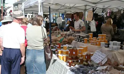 a group of people standing at a farmers market at Greengarth in Keswick