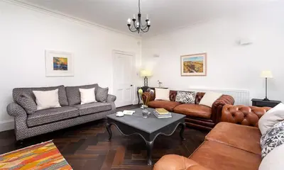 a living room with couches and a coffee table at Ben House in Grasmere
