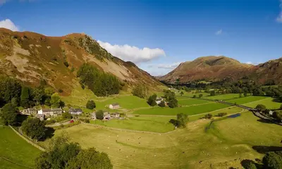 an aerial view of a village in the mountains at Felldale in Glenridding