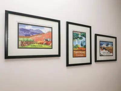 four framed pictures hanging on a wall at Weir Cottage in Ambleside