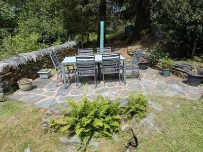 a table and chairs sitting on a stone patio at Wythebank in Ambleside
