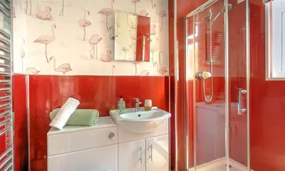 a bathroom with a sink and a shower at Little Leveret Cottage in Keswick